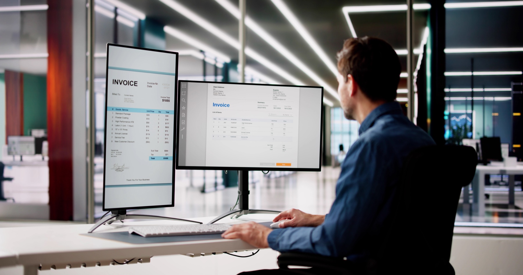 An analyst reviewing a report across two monitors